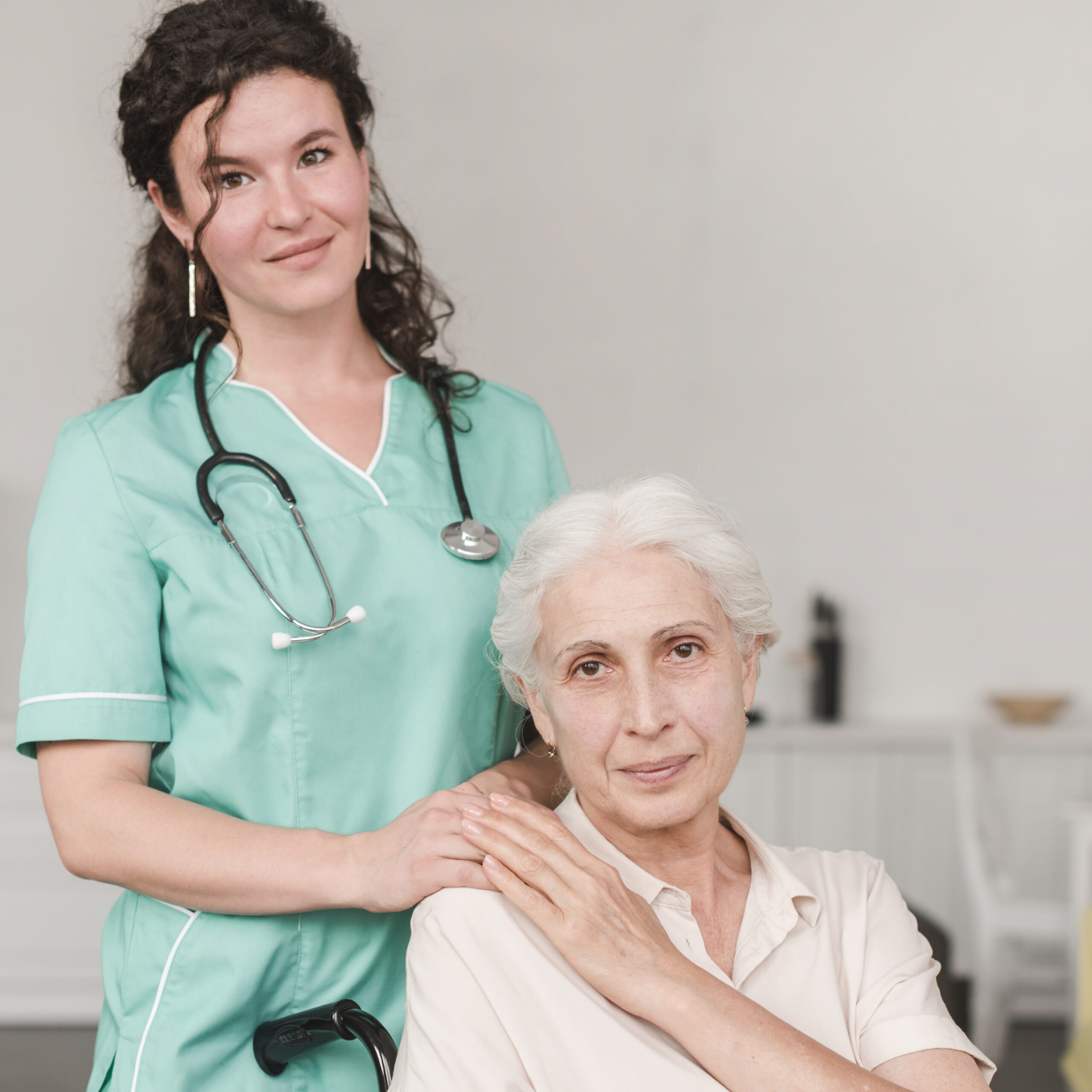 portrait female nurse with her senior patient sitting wheel chair scaled